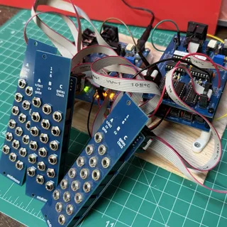 Photograph of three of these Midimuso Breakout Boards connected to three Midimuso CV-12 boards, connected via ribbon cables