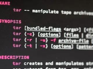 image of a unix `man` page for `tar` with its many difficult options